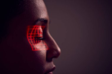 Facial Recognition Technology Concept As Woman Has Red Grid Projected Onto Eye In Studio clipart