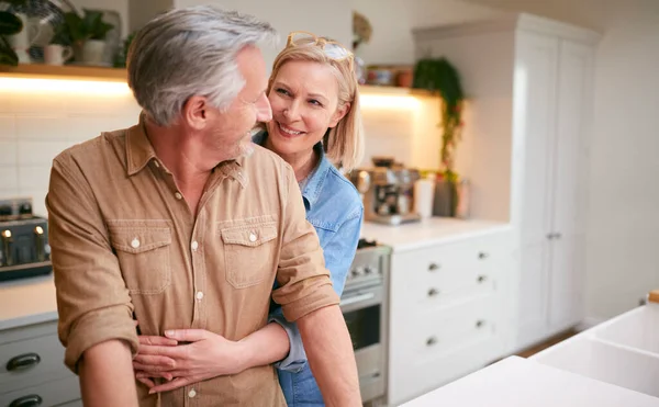 Loving Mature Couple Hugging Stand Counter Kitchen Home — Stok Foto