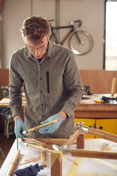 ワークショップで男性職人が手組みで持続可能な竹自転車フレームを構築 — ストック写真