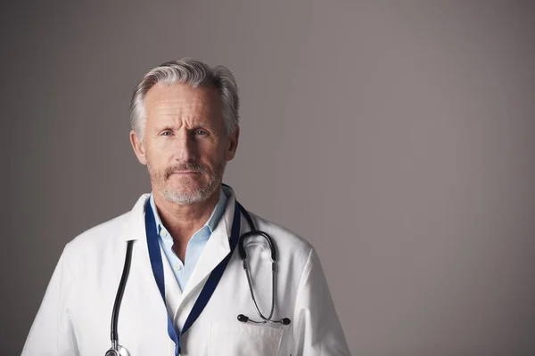 Studio Portrait Mature Male Doctor Wearing White Coat Standing Grey — Stock Photo, Image