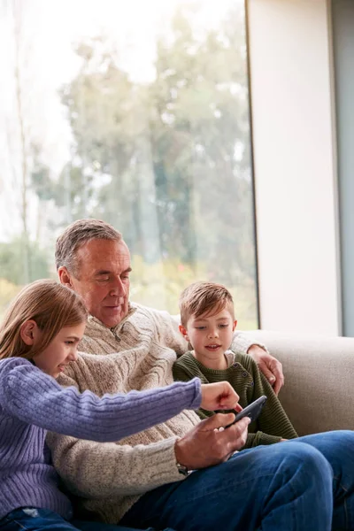 Nipotini Sul Divano Casa Che Mostrano Nonno Come Usare Telefono — Foto Stock