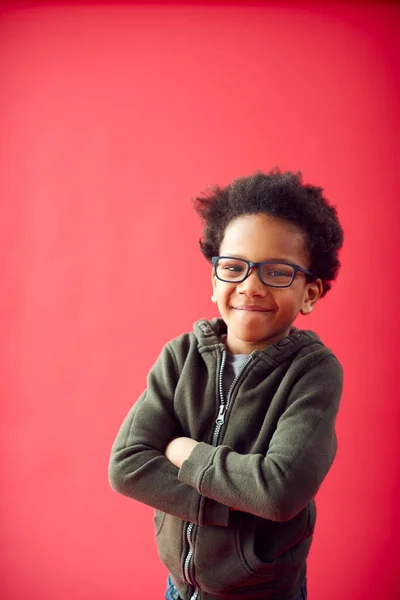 Portrait Boy Wearing Glasses Folded Arms Red Studio Background Smiling — Stok Foto