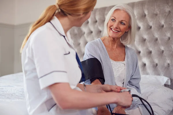 Kvinnlig Läkare Gör Hem Besök Hos Äldre Kvinna Sovrummet För — Stockfoto