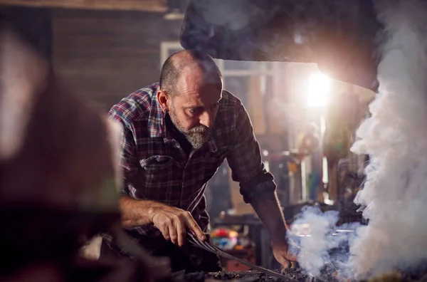 Male Blacksmith Raking Coals Fuel Start Blaze Forge — Stock Photo, Image