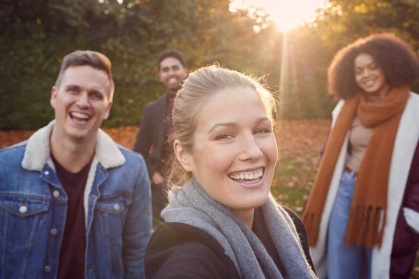 Portrait Of Multi Cultural Group Of Friends Enjoying Outdoor Walk In Fall Or Winter Countryside