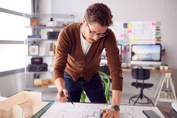 Male Architect Standing Desk Office Amending Building Plans — Stockfoto