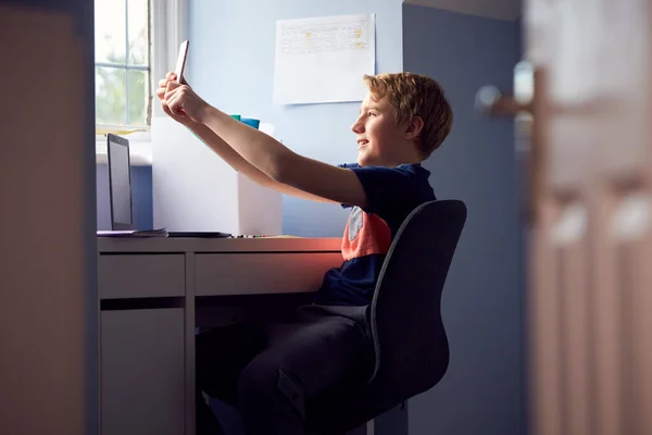 Boy Sitting Desk Home Schooling Taking Selfie Mobile Phone Laptop — Stock Photo, Image