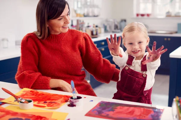 Mother Daughter Showing Messy Hands Home Doing Craft Painting Picture — Stock Photo, Image