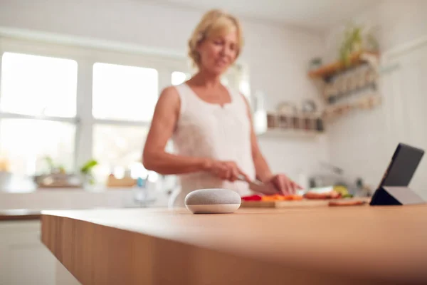 Retired Woman Making Meal Kitchen Smart Speaker Foreground — Stock Photo, Image