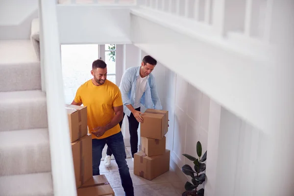 Excited Male Couple Carrying Boxes Front Door New Home Moving — Stock Photo, Image