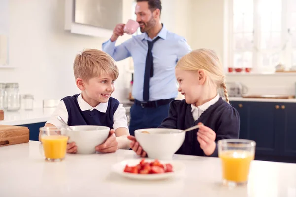 Two Children Wearing School Uniform Kitchen Eating Breakfast Father Gets — Stock Photo, Image