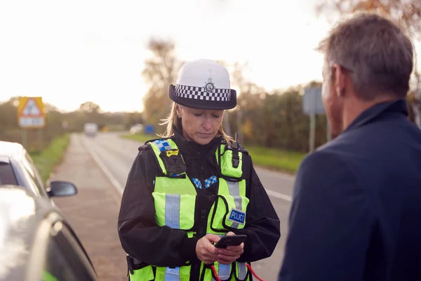 交通警务人员使用流动电话向道路交通意外司机录取证人陈述书 — 图库照片