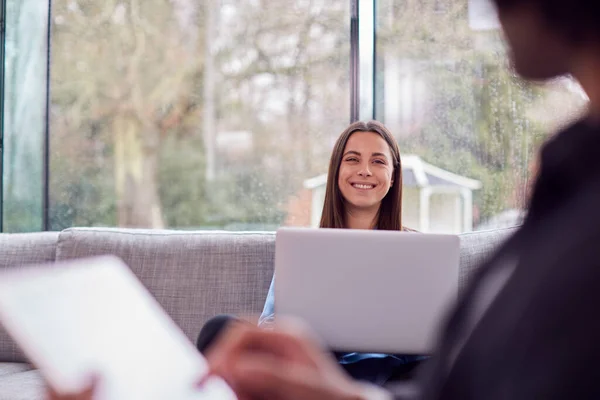 Relaxed Young Couple Home Sitting Sofa Using Digital Tablet Laptop — 스톡 사진