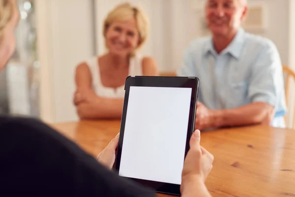 退休人士与家庭理财顾问会面后 数码平板电脑空白屏幕上的特写 — 图库照片