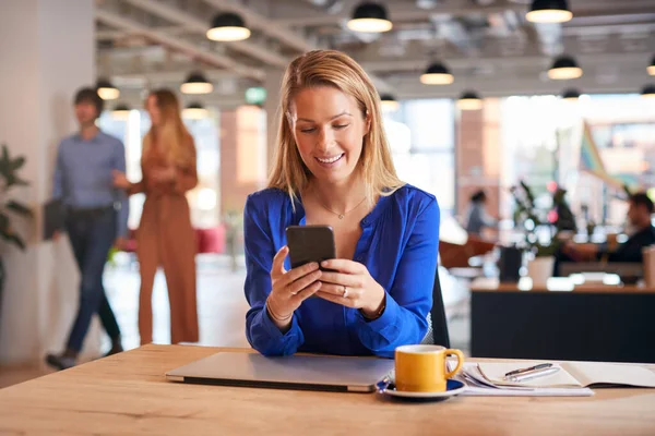 Joven Empresaria Sentada Escritorio Usando Teléfono Móvil Oficina Moderna Planta — Foto de Stock