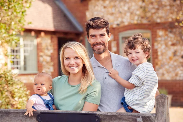 Retrato Familia Sonriente Pie Junto Puerta Fuera Casa Campo Juntos — Foto de Stock