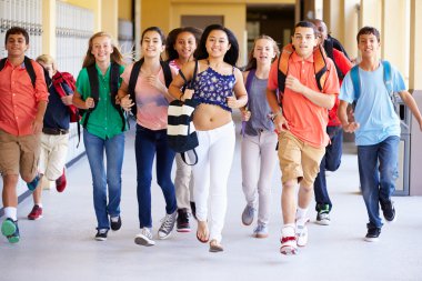 Group Of Students Running Along Corridor clipart