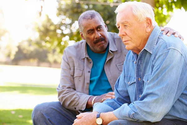 Man Comforting Unhappy Senior Friend Outdoors — Stock Photo, Image