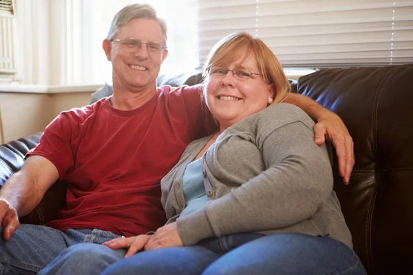 Mature Couple Sitting On Sofa — Stock Photo, Image