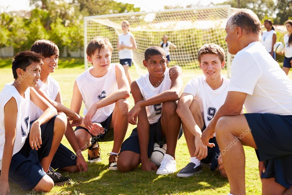 Coach Giving Team Talk To Soccer Team Stock Photo by ©monkeybusiness