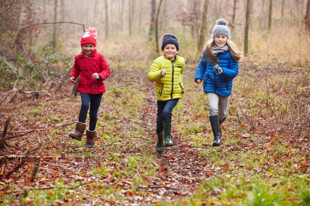 Children Running Through Autumn Forest — Stock Photo © monkeybusiness