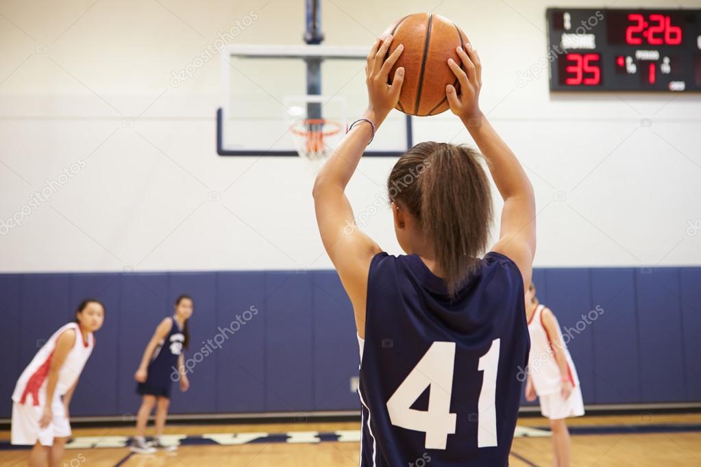 Female Basketball Player Shooting Basket Stock Photo by ©monkeybusiness