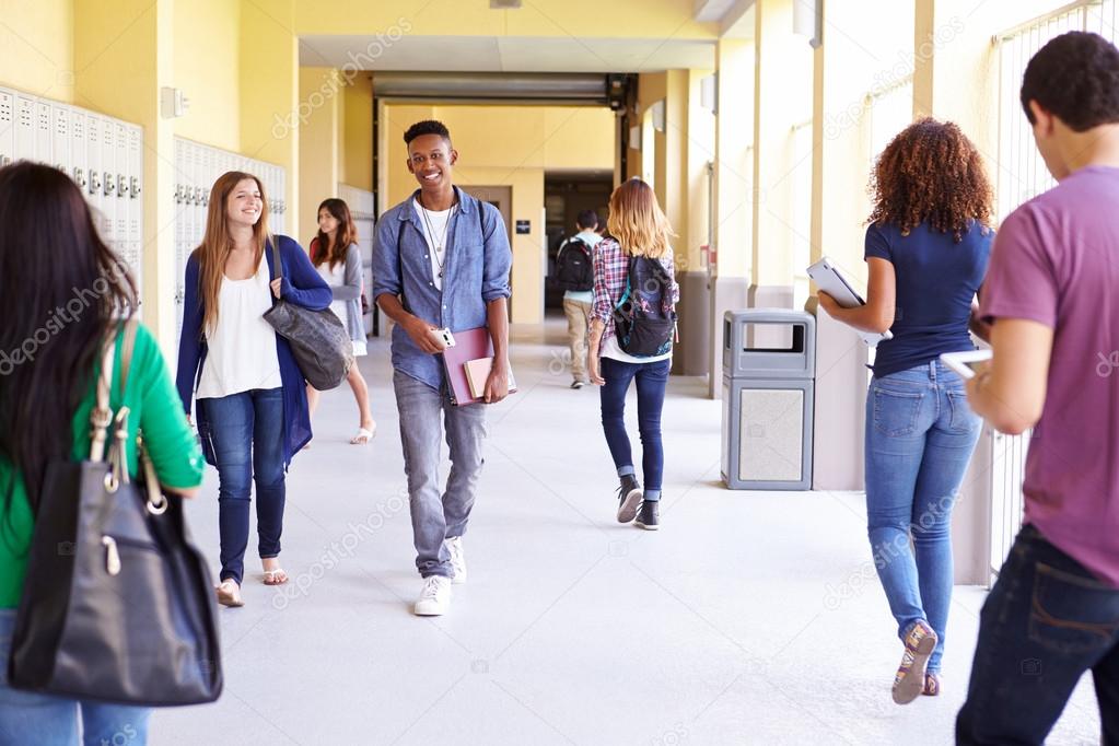 Group Of Students Walking Along Hallway — Stock Photo © monkeybusiness