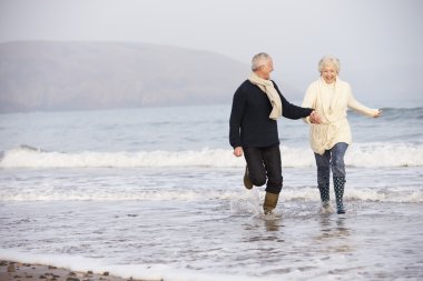 Senior Couple on Winter Beach clipart