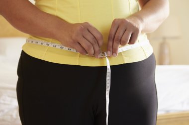 Overweight Woman Measuring Waist clipart