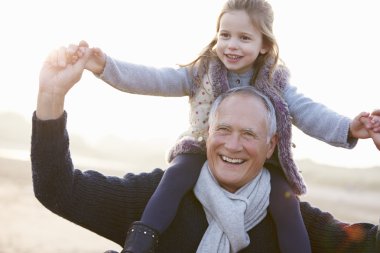 Grandfather And Granddaughter On Beach clipart