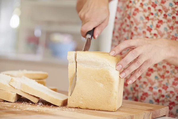 Woman Slicing Loaf Of Bread — Stock Photo, Image