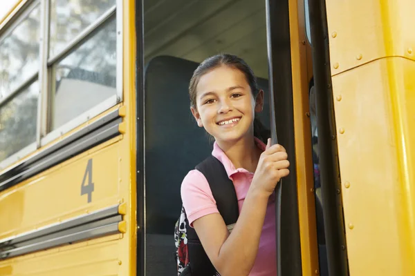 Girl getting on school bus — Stock Photo, Image