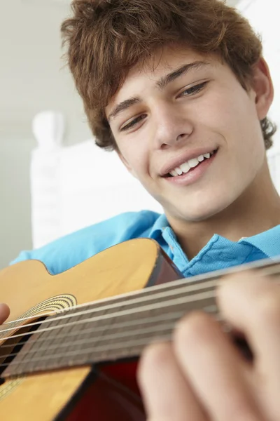 Boy playing acoustic guitar — Stock Photo, Image