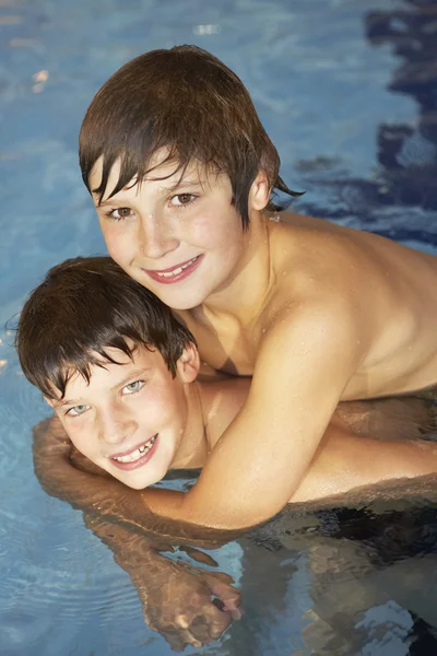 Niño y niña en la piscina — Foto de Stock