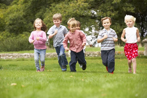 Children running in park Stock Photo