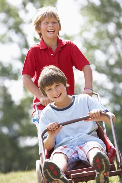 Boys playing with go-kart Royalty Free Stock Images