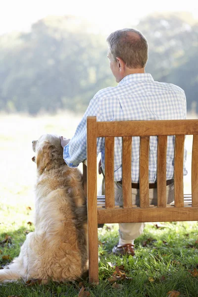 Senior man  outdoors with dog — Stock Photo, Image