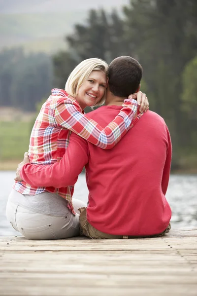 Romantic couple on a jetty — Stock Photo, Image