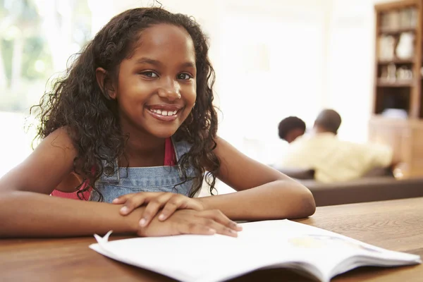 Menina leitura livro para lição de casa — Fotografia de Stock