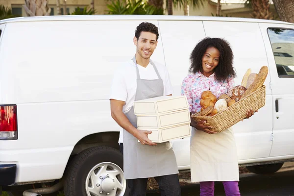 Bakers Unloading Bread And Cakes