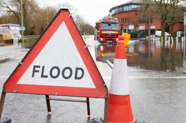 Warning Traffic Sign On Flooded Road clipart