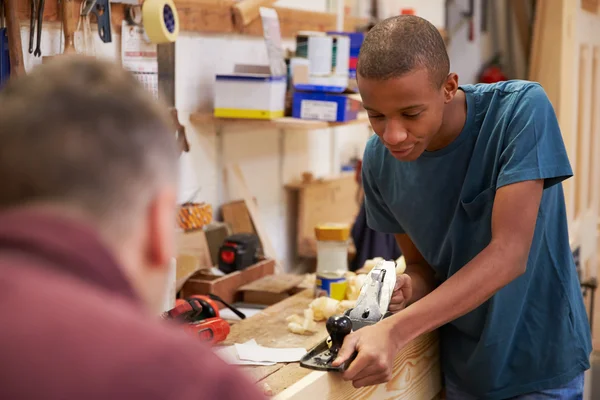 Charpentier avec apprenti rabotage bois — Photo