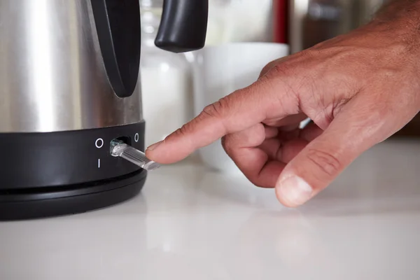 Man Turning On Switch To Boil Kettle — Stock Photo, Image