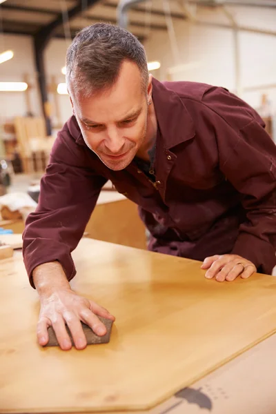 Carpenter Finishing Wood In Workshop — Stock Photo, Image