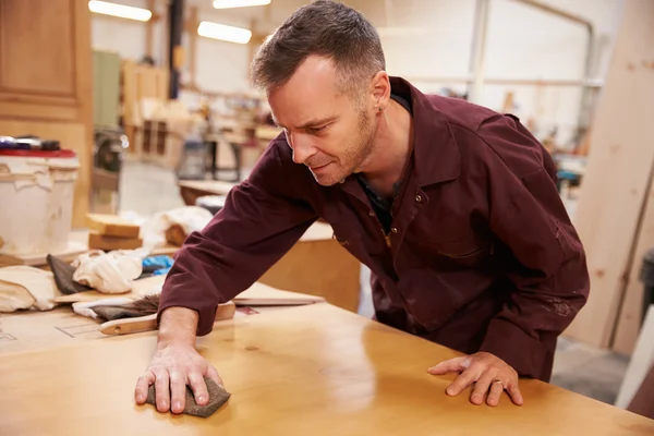 Carpenter Finishing Wood In Workshop — Stock Photo, Image