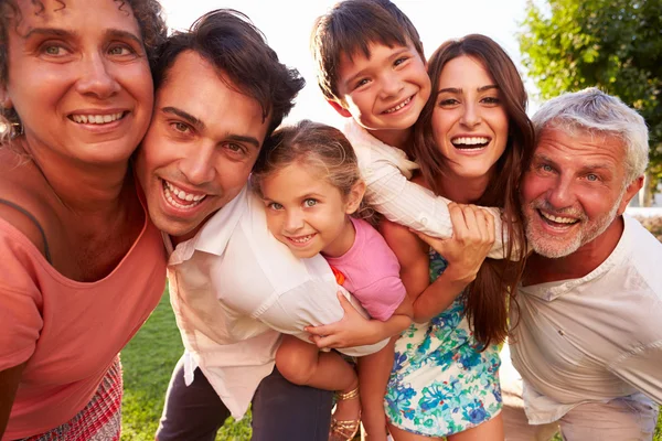 Multi Generation Family  On Grass Together Stock Picture