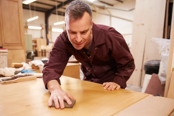 Carpenter Finishing Wood In Workshop — Stock Photo, Image