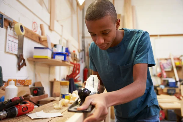 Apprentice Planing Wood In Workshop — Stock Photo, Image