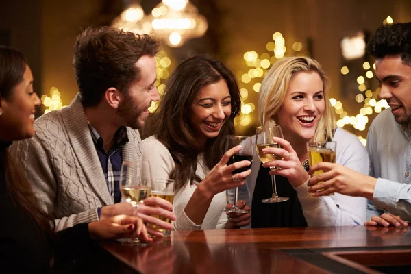 Group Of Friends Enjoying Drinks In Bar Stock Photo