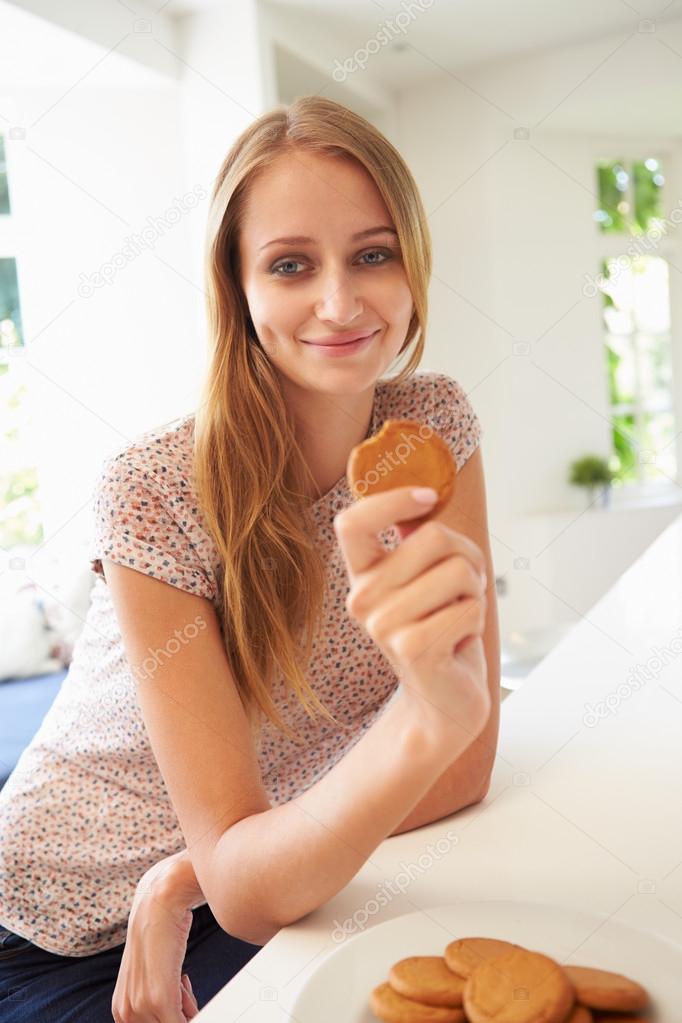 Woman Eats Ginger Biscuit Stock Photo by ©monkeybusiness 68252001